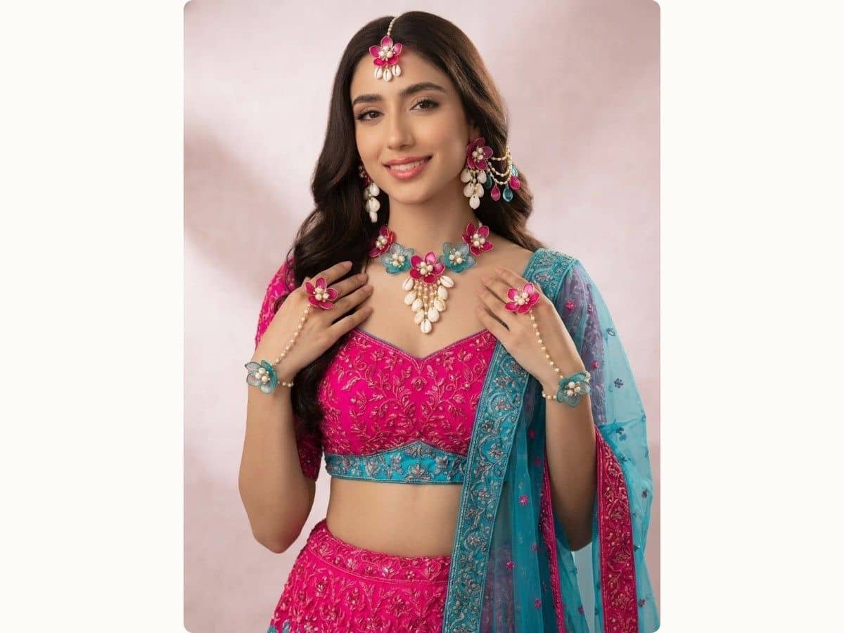 Hot pink and sky blue resin flowers with pearl-style beads and white shell-shaped drops on a necklace, earrings, maang tikka and haathphool