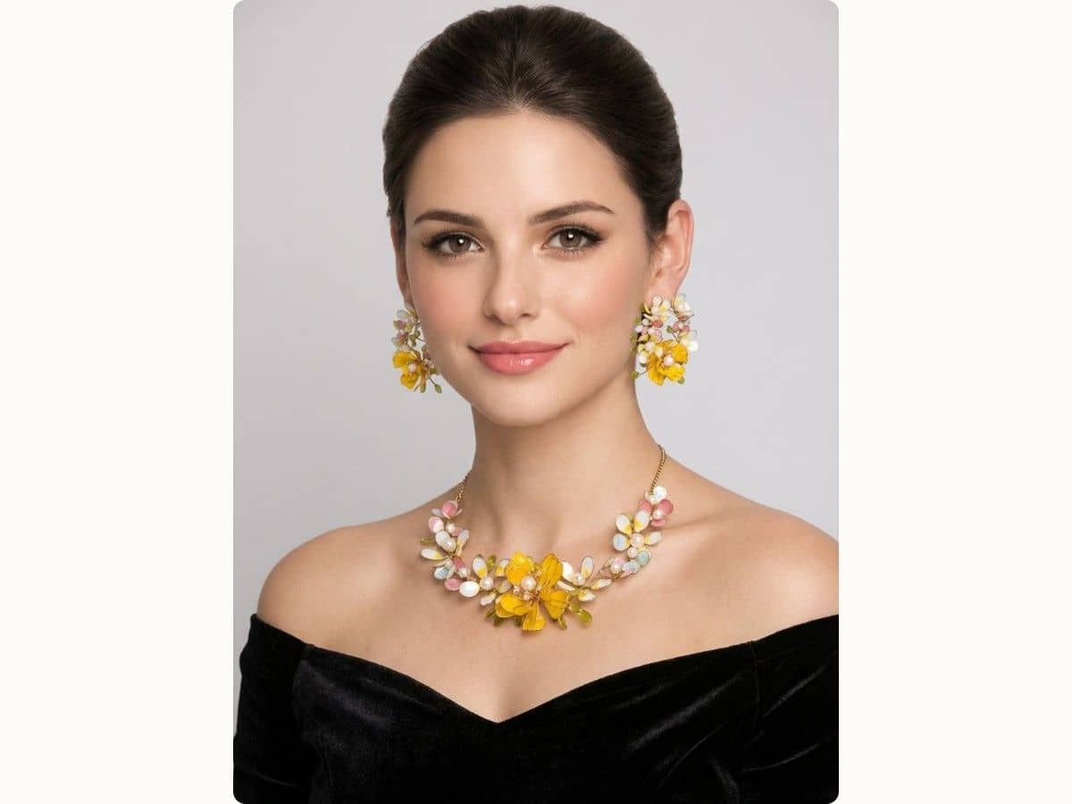 Resin necklace with a large yellow flower framed by small pink and off-white blooms, with matching cluster earrings